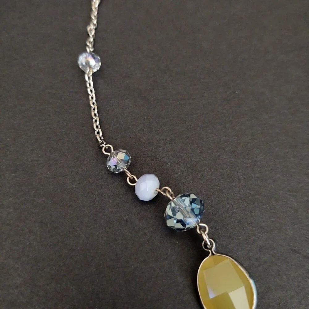 Long silver necklace with blue and yellow glass beads